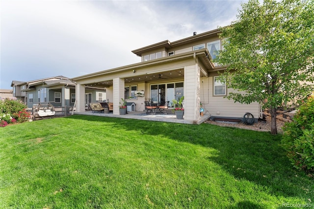 19429 W 88th Dr, Arvada, CO 80007 - back of property featuring a patio, a yard, and a ceiling fan