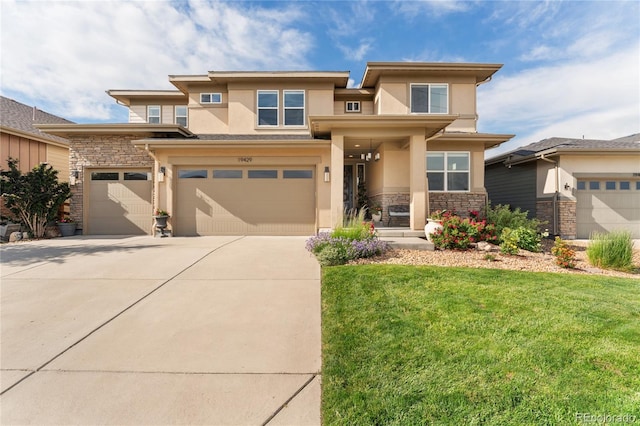 19429 W 88th Dr, Arvada, CO 80007 - prairie-style house with stucco siding, stone siding, concrete driveway, a front yard, and a garage