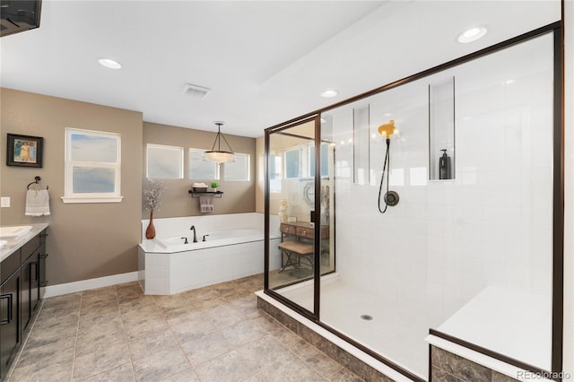 19429 W 88th Dr, Arvada, CO 80007 - bathroom featuring a bath, a tile shower, vanity, and recessed lighting