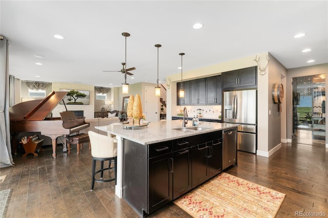 19429 W 88th Dr, Arvada, CO 80007 - kitchen with appliances with stainless steel finishes, dark wood-type flooring, light stone counters, ceiling fan, and recessed lighting