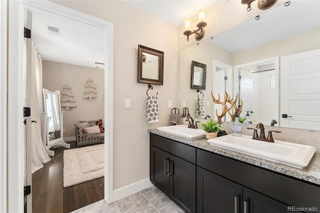 19429 W 88th Dr, Arvada, CO 80007 - bathroom with double vanity and baseboards
