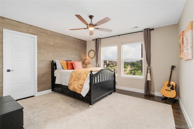 19429 W 88th Dr, Arvada, CO 80007 - bedroom featuring an accent wall, wood finished floors, and a ceiling fan