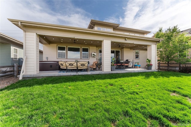 19429 W 88th Dr, Arvada, CO 80007 - rear view of property featuring ceiling fan, a patio, an outdoor hangout area, and a hot tub