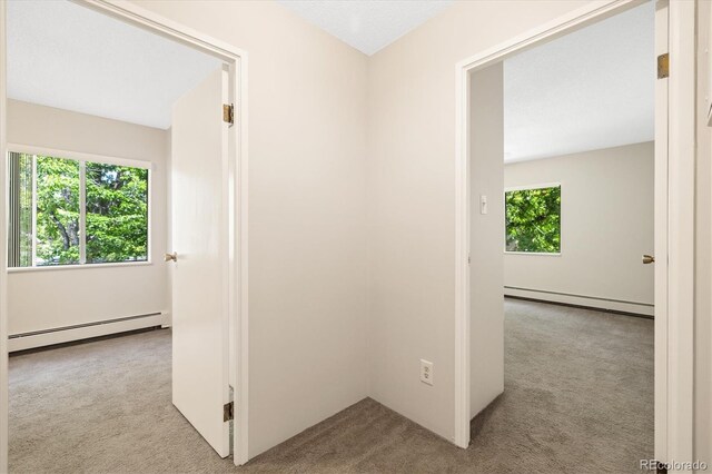3082 S Wheeling Way Unit 202, Aurora, CO 80014 - corridor featuring a baseboard radiator and carpet