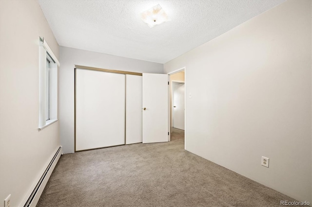 3082 S Wheeling Way Unit 202, Aurora, CO 80014 - unfurnished bedroom with a baseboard radiator, carpet floors, a textured ceiling, and a closet