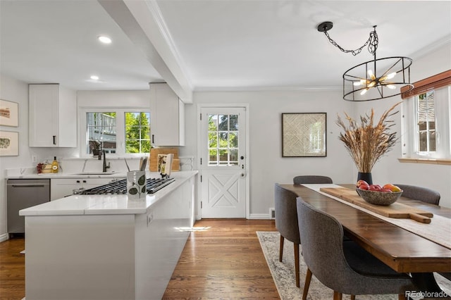 400 Holly St, Denver, CO 80220 - kitchen featuring stainless steel appliances, a chandelier, white cabinetry, ornamental molding, and light countertops