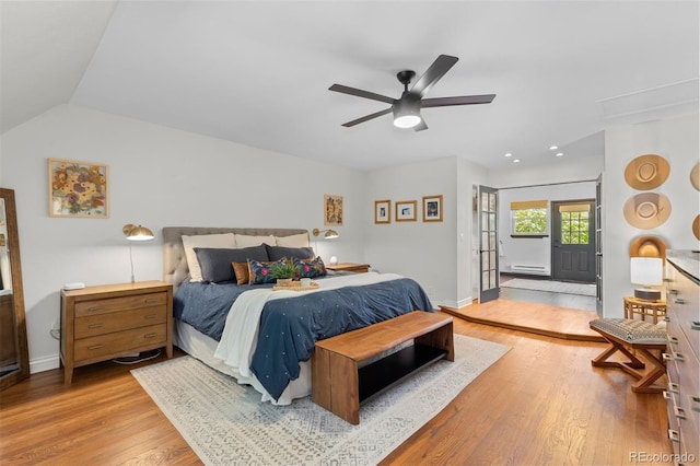 400 Holly St, Denver, CO 80220 - bedroom featuring baseboard heating, light wood finished floors, baseboards, lofted ceiling, and a ceiling fan