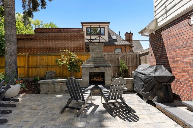 400 Holly St, Denver, CO 80220 - fenced backyard featuring an outdoor stone fireplace, a patio, and area for grilling
