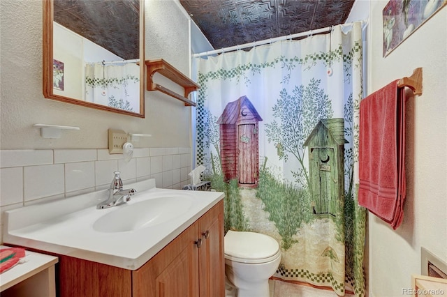 16670 County Road 126, Pine, CO 80470 - bathroom with vanity, toilet, a textured wall, and curtained shower
