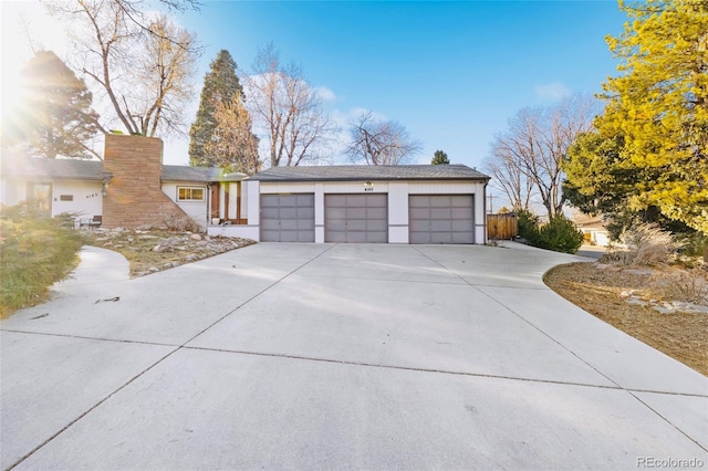 view of front of house with concrete driveway and an attached garage