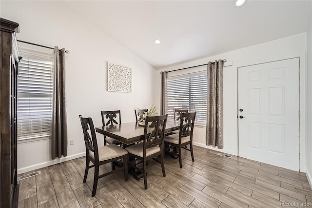 dining area with vaulted ceiling