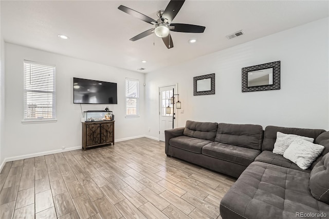 living room featuring ceiling fan and light wood-type flooring