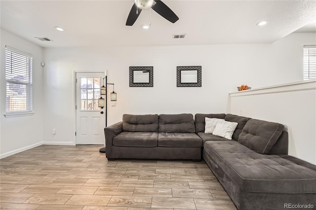 living room with ceiling fan and light hardwood / wood-style floors