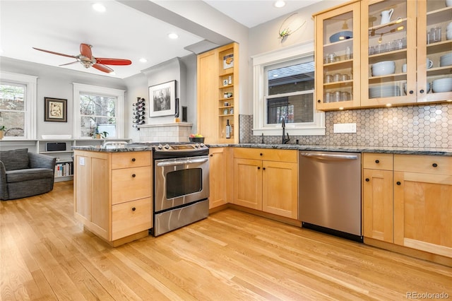 3701 Eliot St, Denver, CO 80211 - kitchen with stainless steel appliances, light brown cabinetry, light wood-style flooring, dark stone counters, and recessed lighting