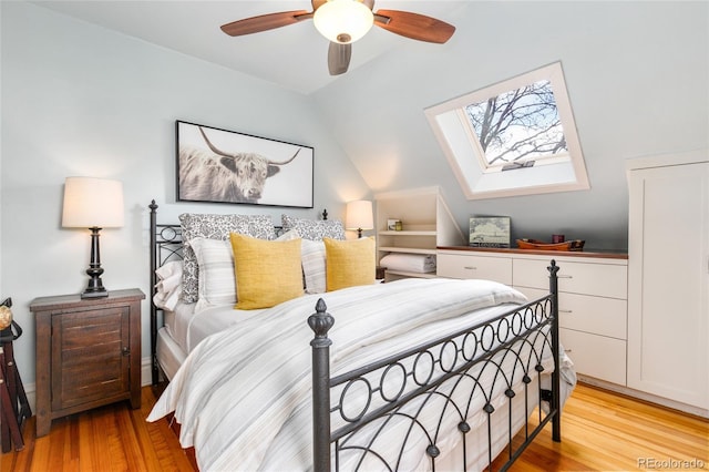 3701 Eliot St, Denver, CO 80211 - bedroom featuring light wood finished floors, a skylight, vaulted ceiling, and ceiling fan
