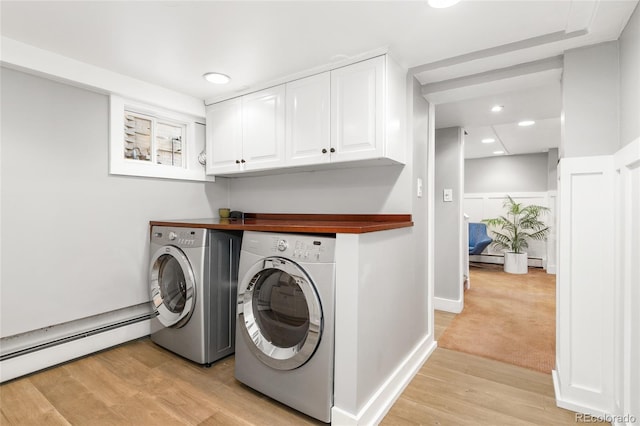 3701 Eliot St, Denver, CO 80211 - laundry area featuring a baseboard radiator, washing machine and dryer, cabinet space, light wood finished floors, and recessed lighting