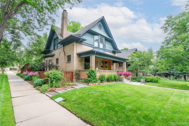 3701 Eliot St, Denver, CO 80211 - view of front facade featuring covered porch, brick siding, and a chimney
