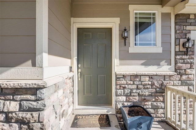 3620 Sandoval St, Brighton, CO 80601 - doorway to property with stone siding and covered porch