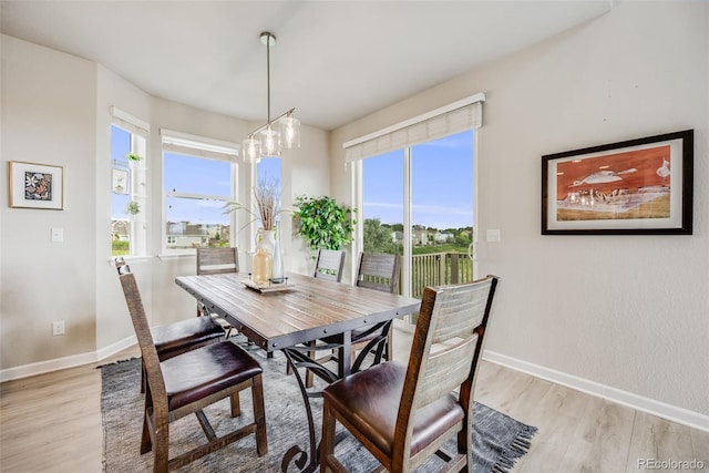 3620 Sandoval St, Brighton, CO 80601 - dining room with light wood-type flooring, plenty of natural light, and a chandelier