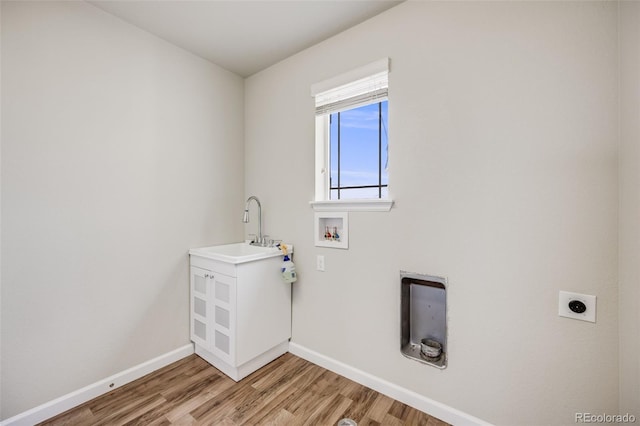 3620 Sandoval St, Brighton, CO 80601 - washroom with hookup for an electric dryer, hookup for a washing machine, and light wood-type flooring