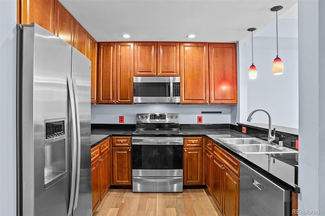 kitchen with stainless steel appliances, brown cabinetry, and a sink