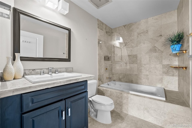 bathroom featuring toilet, tiled shower / bath combo, tile patterned floors, visible vents, and vanity