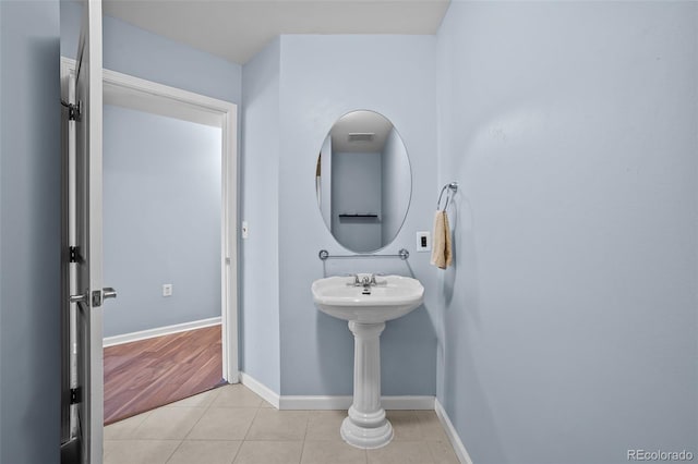 bathroom featuring baseboards, tile patterned floors, and visible vents