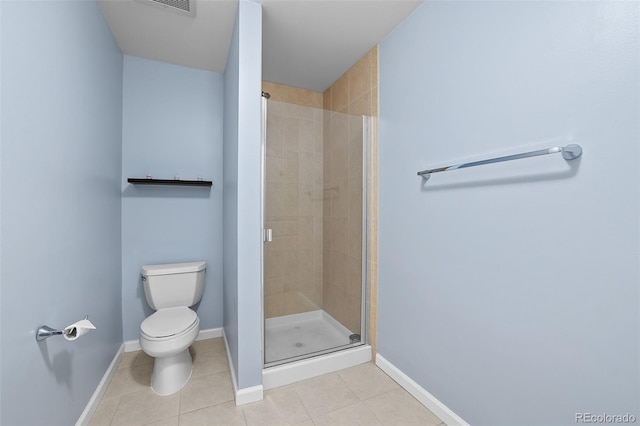 bathroom featuring toilet, baseboards, a shower stall, and tile patterned floors