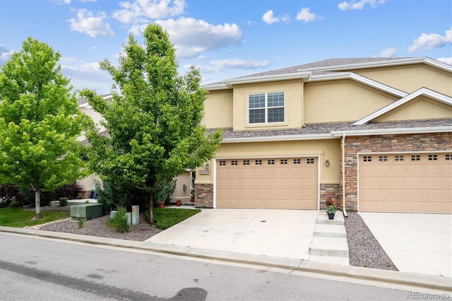 22391 E Plymouth Cir, Aurora, CO 80016 - view of front of home featuring stucco siding, stone siding, concrete driveway, and an attached garage