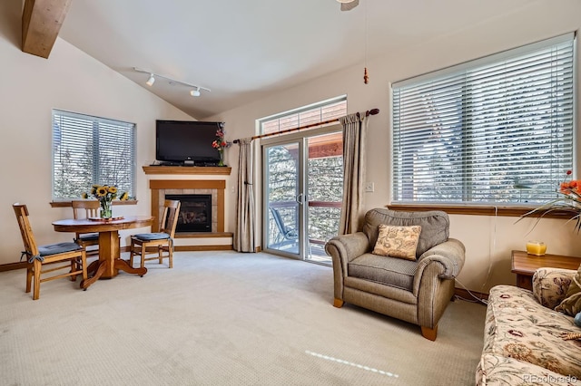 846 Blue River Pkwy Unit C2, Silverthorne, CO 80498 - living area featuring vaulted ceiling with beams, a tile fireplace, and carpet