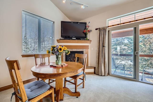 846 Blue River Pkwy Unit C2, Silverthorne, CO 80498 - dining space featuring baseboards, lofted ceiling, carpet floors, and a tile fireplace