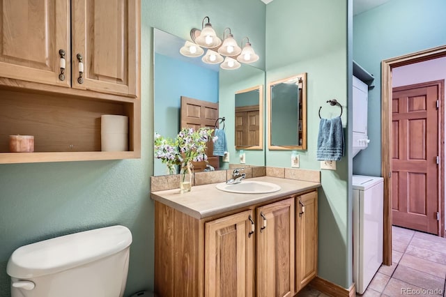 846 Blue River Pkwy Unit C2, Silverthorne, CO 80498 - bathroom featuring tile patterned flooring, vanity, toilet, stacked washer and dryer, and a notable chandelier