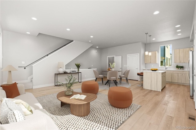 4737 E Iliff Ave, Denver, CO 80222 - living room featuring stairway, recessed lighting, and light wood finished floors