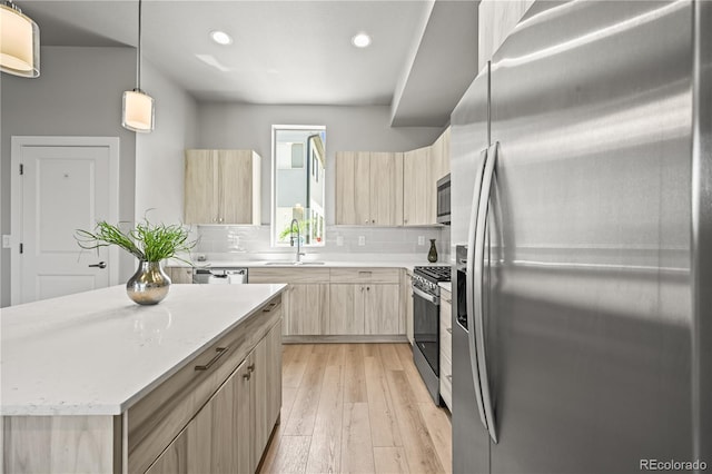4737 E Iliff Ave, Denver, CO 80222 - kitchen with appliances with stainless steel finishes, light brown cabinetry, recessed lighting, modern cabinets, and light wood-type flooring