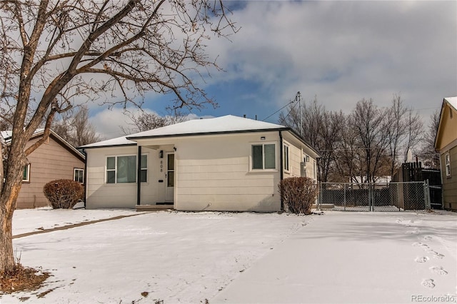 view of snow covered back of property