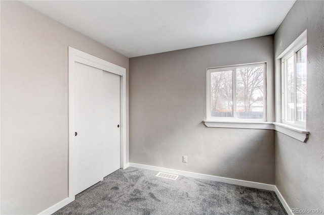 unfurnished bedroom with a closet and carpet