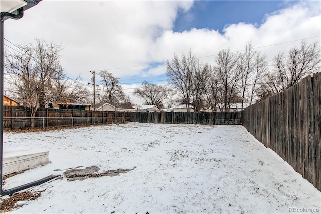 view of yard layered in snow