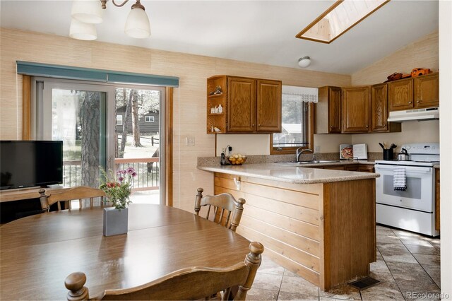 29101 Drexel Spur, Evergreen, CO 80439 - kitchen featuring white range with electric stovetop, under cabinet range hood, a peninsula, healthy amount of natural light, and lofted ceiling