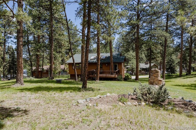29101 Drexel Spur, Evergreen, CO 80439 - view of front facade with a wooden deck and a front lawn