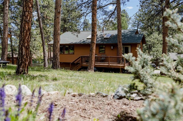 29101 Drexel Spur, Evergreen, CO 80439 - rear view of house featuring a wooden deck and roof with shingles