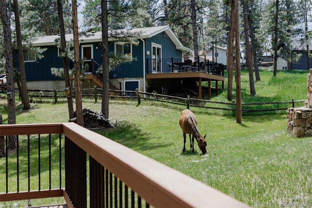 29101 Drexel Spur, Evergreen, CO 80439 - fenced yard featuring a wooden deck and stairway