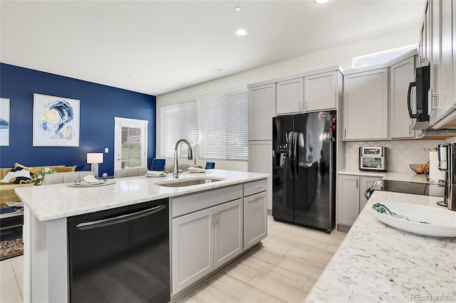 12258 Hazel Spruce Ct, Parker, CO 80134 - kitchen featuring black appliances, a sink, gray cabinets, a center island with sink, and recessed lighting