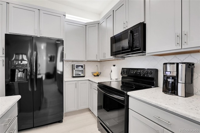 12258 Hazel Spruce Ct, Parker, CO 80134 - kitchen featuring black appliances, light stone countertops, and decorative backsplash