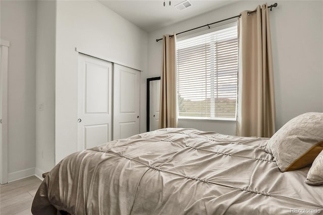 12258 Hazel Spruce Ct, Parker, CO 80134 - bedroom with a closet, light wood-type flooring, and baseboards