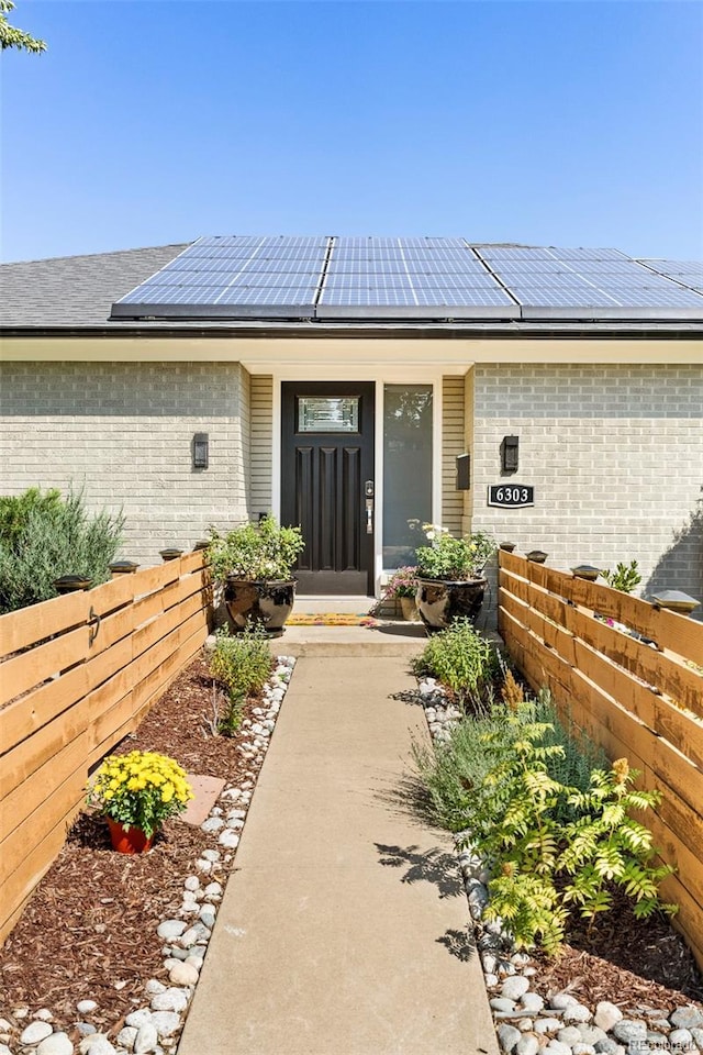 doorway to property with solar panels