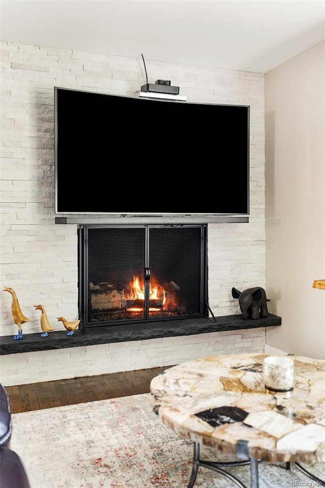 interior details featuring wood-type flooring and a fireplace