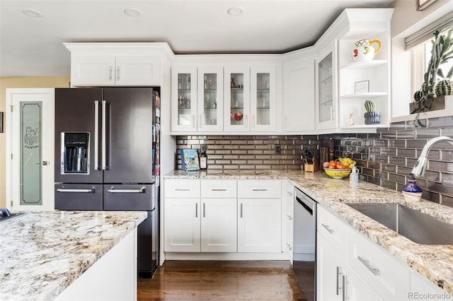 kitchen featuring sink, white cabinetry, appliances with stainless steel finishes, dark hardwood / wood-style floors, and light stone countertops