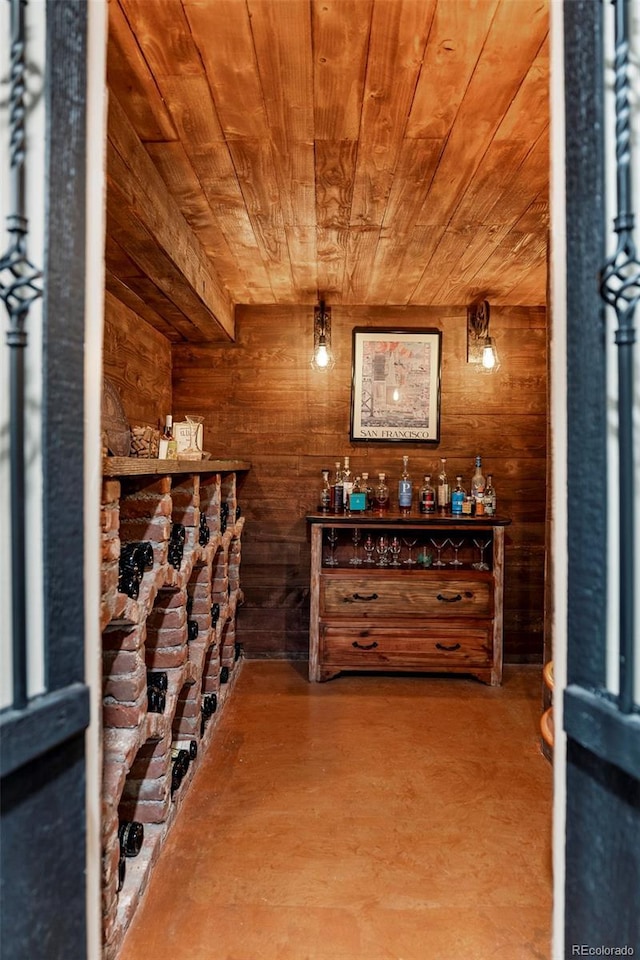 wine area with wooden walls and wood ceiling