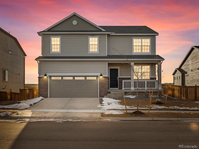 view of property featuring a garage and covered porch