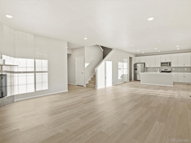 unfurnished living room featuring light wood-type flooring